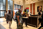 ANC SG Fikile Mbalula walks past a painting of former president Jacob Zuma. File image
