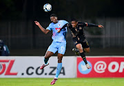 Ime Okon of SuperSport and Motebang Sera of Royal AM engage in an aerial battle during Wednesday’s game. 