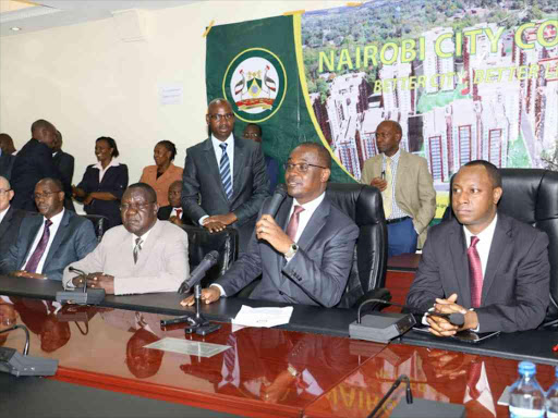Nairobi county secretary Robert Ayisi (in white suit), Governor Evans Kidero and Deputy Governor Jonathan Mueke (R) during the awarding of contracts to private investors to build new houses on November 22 / JULIUS OTIENO