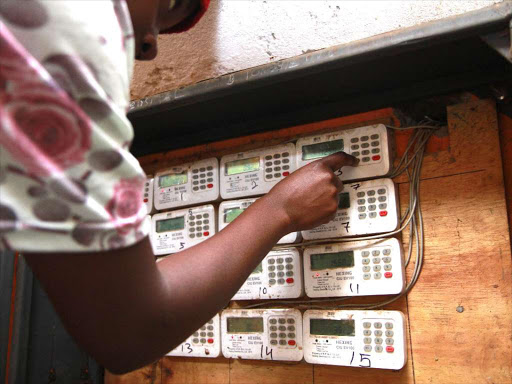 A Kenya Power prepaid user loads her metre in Kangemi estate on April 25,2018 / ENOS TECHE