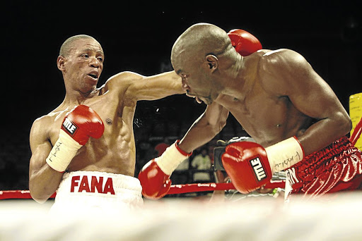 Mzonke Fana throws a left hook at Cassius Baloyi in this file picture. Fana says he has not applied to Boxing SA to be relicensed as a boxer.