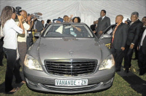 LUXURY GIFT: Minister of Transport S'bu Ndebele and his wife Zama show off the car they received as a gift from KwaZulu-Natal Vukuzakhe Constructors at a ceremony to honour him after his appointment at Woodburn Stadium. PHOTO: SIYABONGA MOSUNKUTU