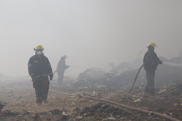 Fire fighters fight to put out a blaze at the Msunduzi landfill in Pietermaritzburg since yesterday.