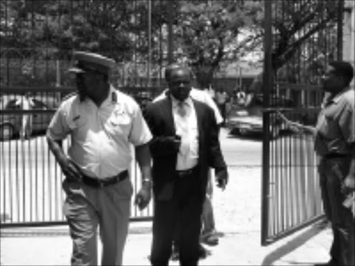 SHOOTING DISASTER: Chief traffic officer Judas Chiloane and Bushbuckridge mayor Milton Morema arrive at the Mhlala police station shortly after the shooting that left two top cops dead yesterday morning. 02/12/2008. Pic. Riot Hlatshwayo. © Sowetan