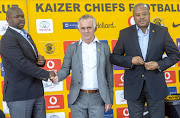 Embattled Kaizer Chiefs head coach Steve Komphela shakes hands with newly appointed technical advisor Rob Hutting while the club's football manager Bobby Motaung 
 watches on during a media briefing at Chiefs Village on January 10, 2018 in Johannesburg, South Africa.