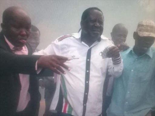 Cord leader Raila Odinga reacts after police lobbed teargas canisters during Opposition protests outside the offices of the IEBC at Anniversary Towers in Nairobi, for the removal of commissioners ahead of the 2017 general election, April 25, 2016. Photo/COURTESY