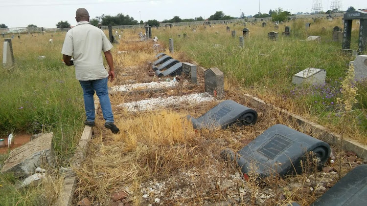 PAC regional leader Samuel Ngidi walks through the graves of the victims of the Sharpeville massacre in the Phelindaba cemetery, another graveyard that has not been well maintained.