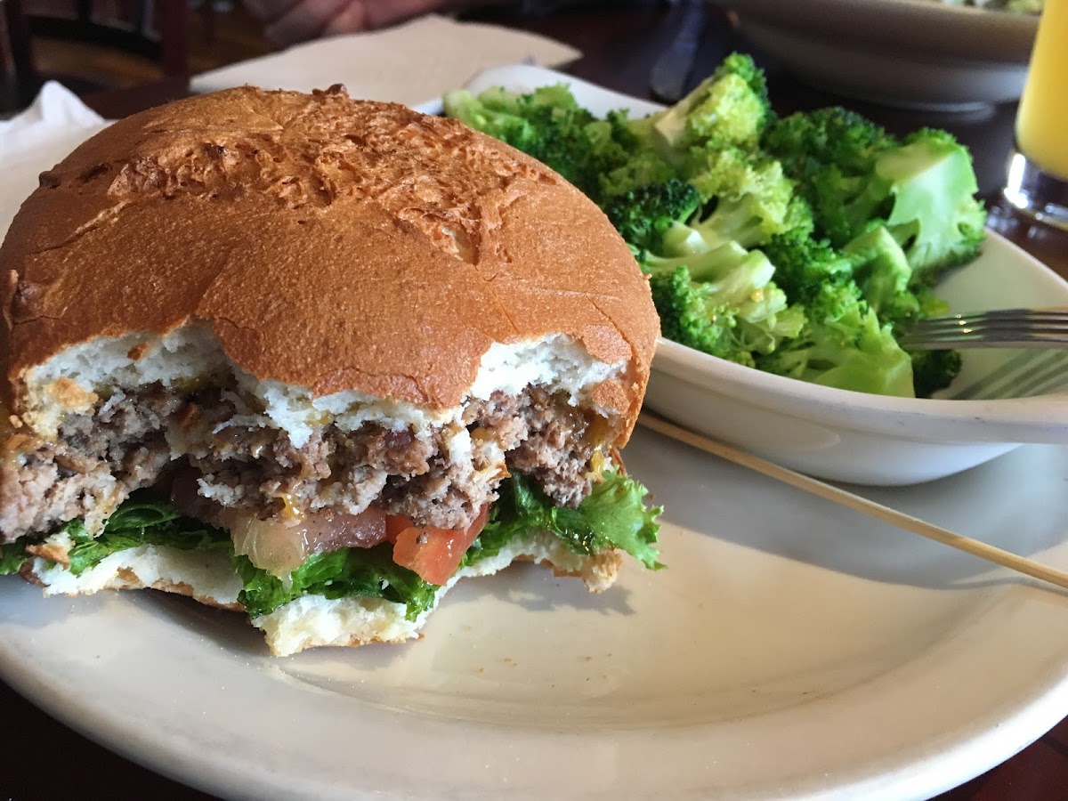 Burger with gluten free bun and stems broccoli