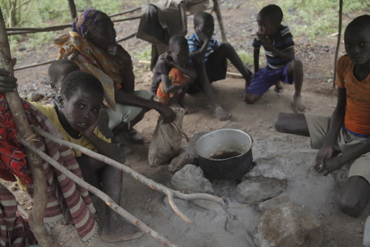 A family displaced by bandits prepare a meal in a temporary structure in Sibilo, Baringo North, on November 5, 2022.