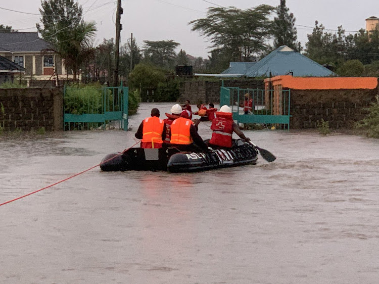 Kenya Red Cross Society officials on a boat during rescue efforts in Kitengela following flooding on May 1, 2024.