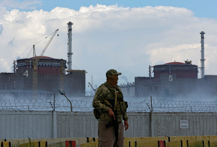A soldier with a Russian flag on his uniform stands guard near the Zaporizhzhia Nuclear Power Plant outside the Russian-controlled city of Enerhodar in the Zaporizhzhia region, Ukraine, August 4 2022. Picture: ALEXANDER ERMOCHENKO/REUTERS