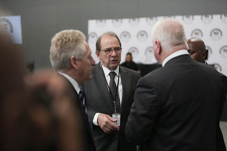 Head of the legal team Advocate Paul Pretorius (Centre) talks to other lawyers during a tea break, 20 August 2018, in Parktown, Johannesburg, during the opening day of the the State Capture Inquiry.