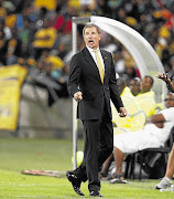 Chiefs' mentor Stuart Baxter, in a gold tie and black suit, Chiefs' colours, said taking instructions from the Bafana coach would make him an amateur