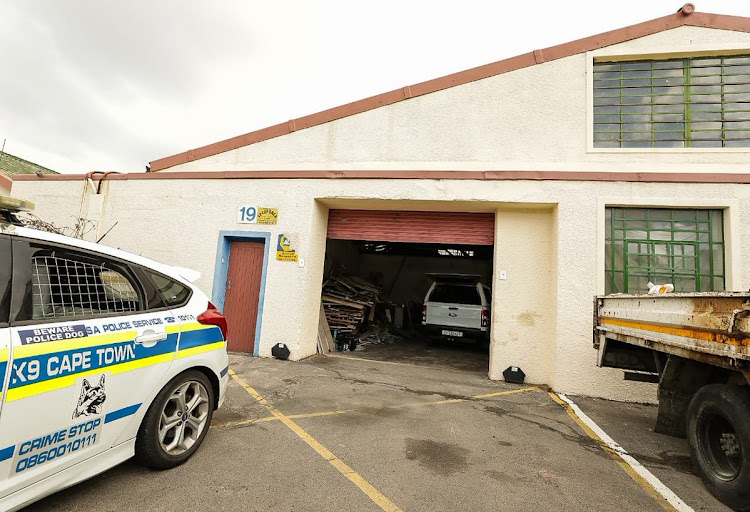 Police in front of a warehouse believed to be an illegal abalone processing facility on Bellville South, on Wednesday afternoon.