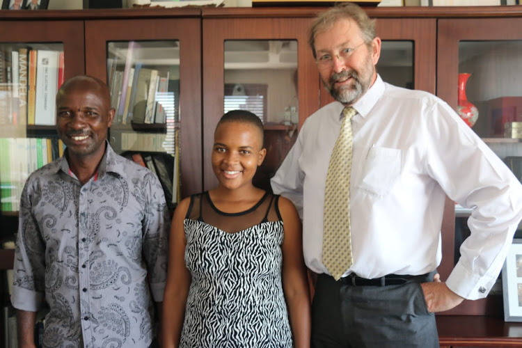 Triphin Mudzvengi with her proud father Polate Mudzvengi and Ian Jandrell, head of the faculty of engineering and the built environment at Wits University.