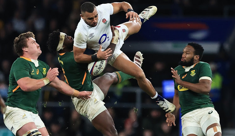Joe Marchant of England is tackled in the air by the Springboks' Siya Kolisi at Twickenham. Image: DAVID ROGERS/GETTY IMAGES