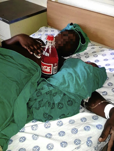 An expectant mother with a red concoction she was caught with in Dilokong's labour ward. / SUPPLIED