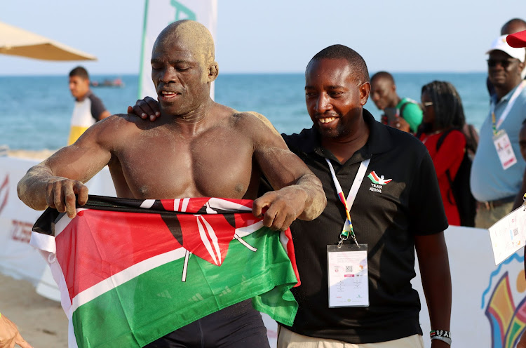 NOC-K secretary general, Francis Mutuku with wrestler Mark Omumasaba after winning silver last month’s Africa Beach Games in Tunisia.