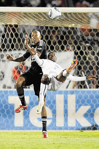 Orlando Pirates' Happy Jele shown blocking Moroka Swallows' Siyabonga Nomvete's bicycle kick earlier this month. Jele will be out of action for more than six months Picture: LEFTY SHIVAMBU/GALLO IMAGES