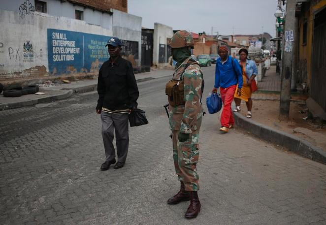 Police and soldiers patrol the streets in Alexandra.