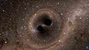 The collision of two black holes—an event detected for the first time ever by the Laser Interferometer Gravitational-Wave Observatory, or LIGO—is seen in this still from a computer simulation. 
