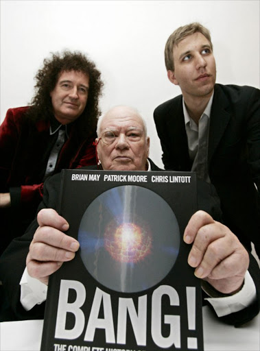 Brian May, (L) guitarist for rock band Queen, joins astronomer Sir Patrick Moore (C) and Chris Lintott during a photocall to launch their book on the history of the universe, entitled 'Bang! The Complete History of the Universe' in central London, 23 October 2006.