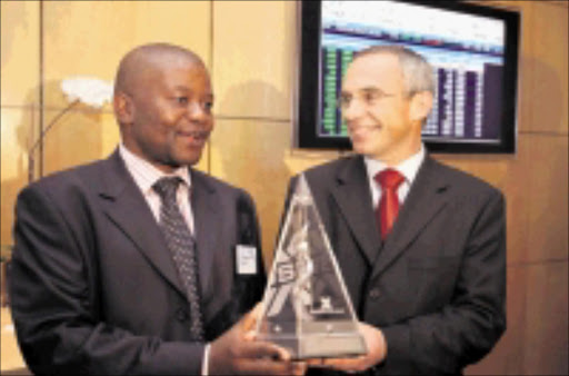 NEW BEGINNING: Incoming Vodacom chairperson Peter Moyo with Vodacom chief executive Pieter Uys at the official listing of the cellphone giant on the JSE yesterday. 18/05/09. © Unknown.