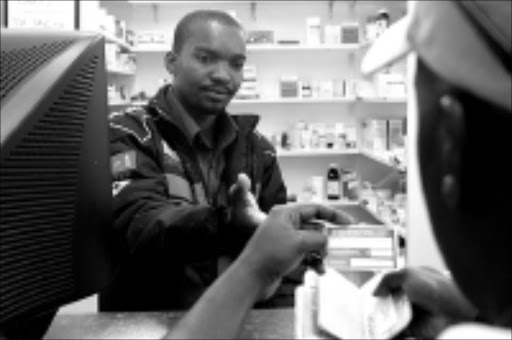 CHECKING UP: Advocate Boyce Mkhize, registrar of the HPCSA, asks to inspect the particulars of a man calling himself Mafala in a raid at the Nedplaza Pharmacy in Arcadia, Pretoria. Pic. Vathiswa Ruselo. © Sowetan.