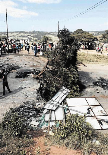 UPROAR: A service delivery protest blocked the road to Chintsa East yesterday Picture: ZWANGA MKHUTHU