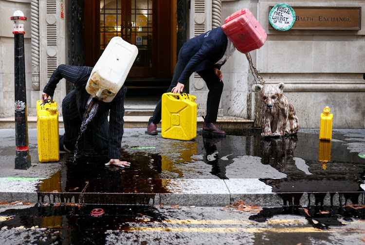 Activists from the climate action group Ocean Rebellion perform a stunt outside The Baltic Exchange building, in London, Britain November 16, 2020.