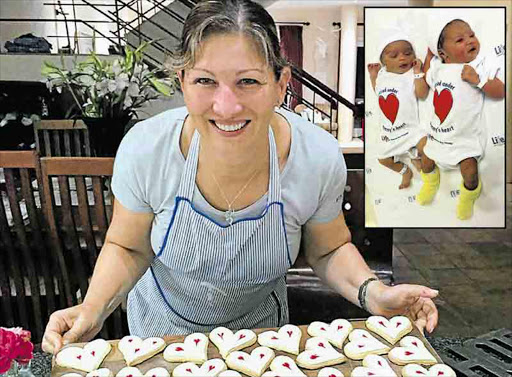 FROM THE HEART: Salut Deli’s Robyn Spring baked heart-shaped biscuits for her Valentine’s Day picnic hampers. INSET: Kubobonke Njokweni and Mohadiah Mopp model the ‘Carried under mommy’s heart’ baby grows Life Beacon Bay is giving to babies born on this day Picture: SUPPLIED/MICHAEL PINYANA