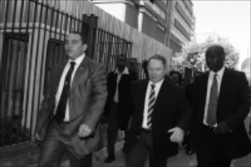 ON THE MARCH: The eighth state witness Aubrey Morris Shlugman (in striped tie) arrives at court to give evidence in the corruption case of former police commissioner Jackie Selebi yesterday. Pic: BAFANA MAHLANGU. 12/11/2009. © Sowetan.