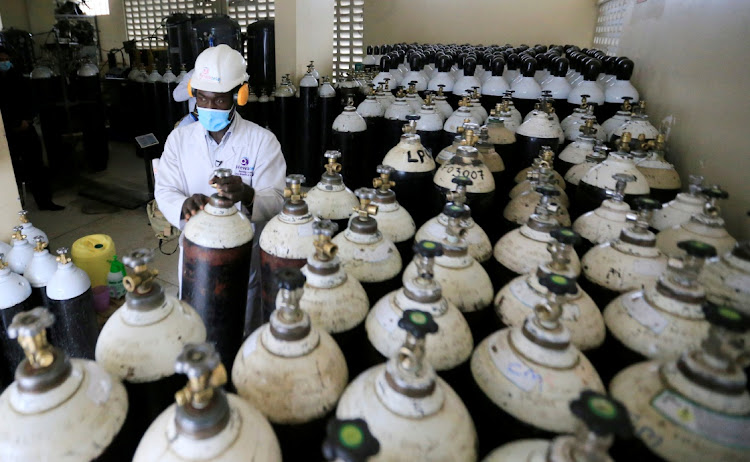 Walter Otieno, plant operator at Hewatele, an innovative oxygen supply company,, arranges empty oxygen medical cylinder tanks amid the coronavirus disease (Covid-19) pandemic, at the Hewatele oxygen plant in Nairobi, Kenya August 3, 2021.