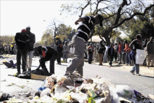PRIME MESS: Pretoria municipal workers highlight their grievances by tossing rubbish in the streets of the city during strike action yesterday. Workers demand wage parity and market-related salaries. Pic: Peggy Nkomo. 13/04/2010. © Sowetan