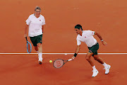 Bill Gates and Roger Federer on their way to a 6-3 victory in their doubles match against Rafael Nadal and Trevor Noah at Cape Town Stadium on February 7 2020.