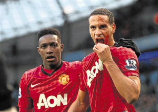 BLOODIED: Manchester United defender Rio Ferdinand, right, is helped by teammate Danny Welbeck after being struck by an object during their Premiership match against Manchester City at Etihad Stadium on Sunday. Photo: Getty Images