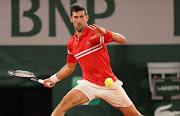 Novak Djokovic of Serbia hits a forehand during his mens singles quarter-final against Matteo Berrettini of Italy on day 11 of the 2021 French Open at Roland Garros  in Paris on June 9, 2021.