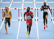 SNEAKING IN:   Cornel Fredericks of South Africa, left, finishes fourth behind  Michael  Tinsley of the US, centre,  in the men's 400m hurdles heats in   the IAAF World Athletics Championships  at the  Luzhniki Stadium in Moscow, Russia, yesterdayPhoto: Getty Images