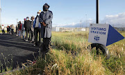 Voters queue in Khayelitsha to cast their vote during the 2021 local government election. 