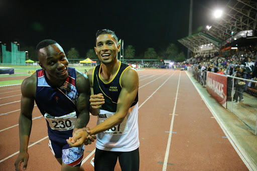 Wayde van Niekerk and Akani Simbine acknowledges the crowd after the men's 100m final during day 1 of the ASA Senior Championships at PUK McArthur Stadium on April 21, 2017 in Potchefstroom, South Africa.