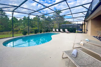 Large west-facing pool deck with conservation view at this Davenport vacation villa