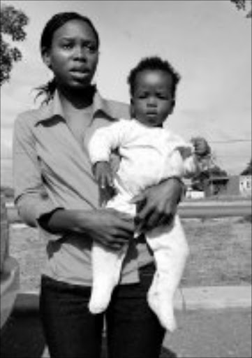 DESPERATE: Nombuso Ngubo with the eight-month-old baby boy she claims was dumped on her doorstep by his mother. Pic. Mhlaba Memela. 14/05/08. © Sowetan.