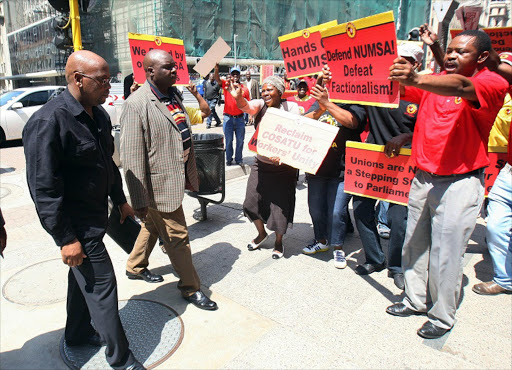 Cosatu president Sidumo Dlamini walks past Numsa supporters. Picture Credit: Veli Nhlapo