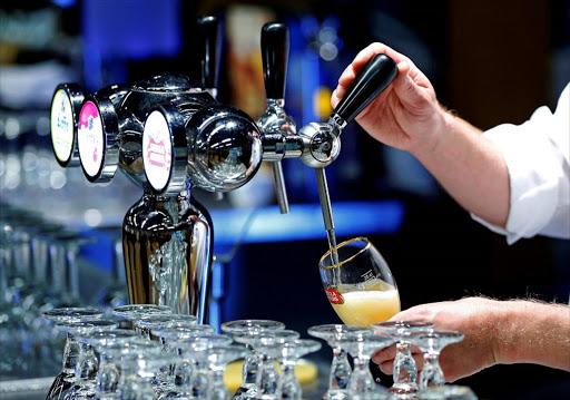 A waiter serves a glass of beer ahead of an Anheuser-Busch InBev shareholders meeting in Brussels, Belgium April 30, 2014. Picture credits: REUTERS