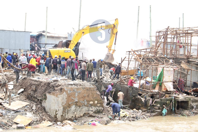 A bulldozer brings down several structures at Mukuru kwa Reuben on May 6, 2024.