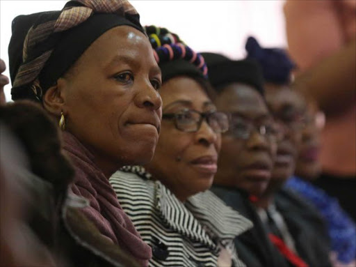 SOMBRE: Rina Malote, 51, front, watches as speakers remember the life of her slain daughter, Lindokuhle Malote, 19, during her funeral at the Assemblies of God Church in NU 2, Mdantsane on Saturday Picture: ALAN EASON