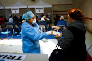 A health worker attends to a person in a gym set up as a Respiratory Care Module where workers of the Mexican Social Security Institute (IMSS) grant sick leaves to patients with Covid-19 in Ciudad Juarez, Mexico, on January 19 2022. 