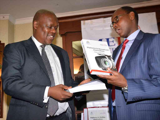 Nation Media Group CEO Joe Muganda with Media Council of Kenya Chairman Charles Kerich after the launch of new Curriculum for journalism. photo/PATRICK VIDIJA