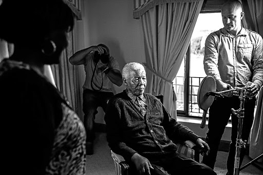 Mandela prepares for his photo shoot. On the left is Kgagare Meme, who manages the Mandela home in Qunu, with Steirn in the background and team member Damon Hyland