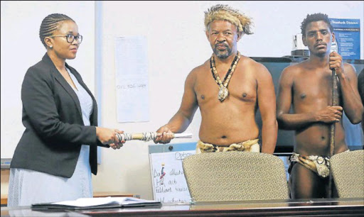MAKE IT HAPPEN: Acting head of Stats SA in the Eastern Cape Ziyanda Ntlebi accepts a memorandum demanding removal of the term ‘coloured’ from Chief Khoisan SA and Shane Plaatjies, who walked from Port Elizabeth to the Quigney offices in East London yesterday Picture: SIBONGILE NGALWA